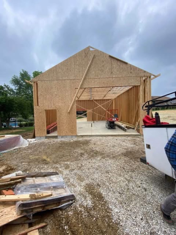 Pole barn under construction with OSB wall sheathing and open framing